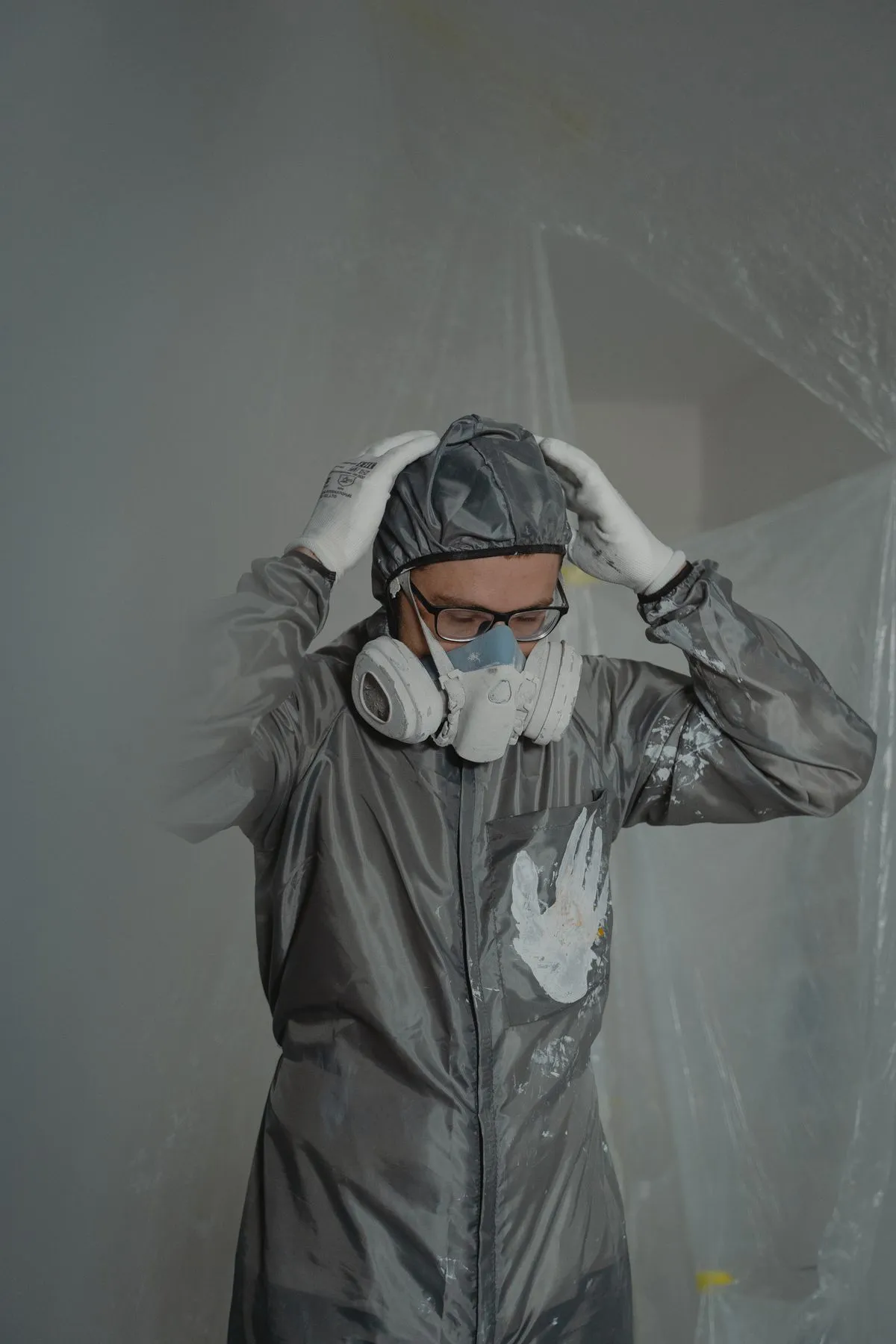 Mold remediation worker wearing protective clothing and a respirator